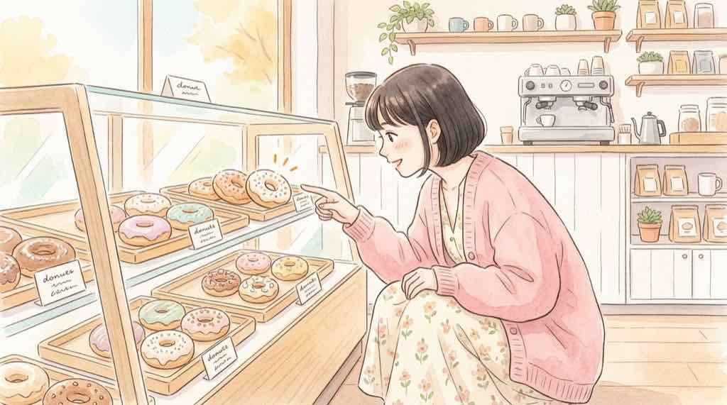 ドーナツショーケースの前でザクショコラに目を輝かせて指差す女性
